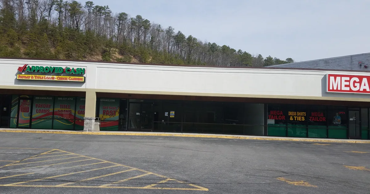 Standard listing photograph of retail storefronts at Twin City Shopping Center in Bluefield, Virginia